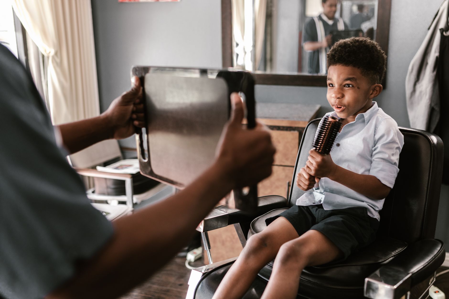 Child having their hair cut at Kelly D's salon