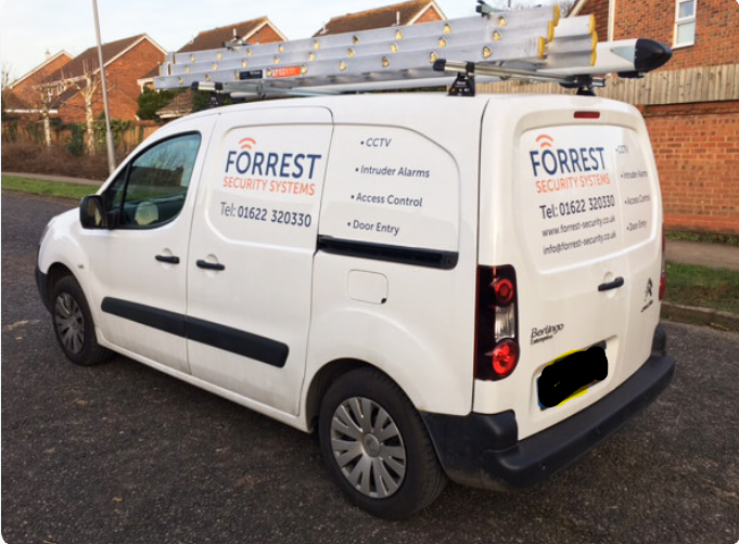 Forrest Security Systems van with ladder rack on a residential street